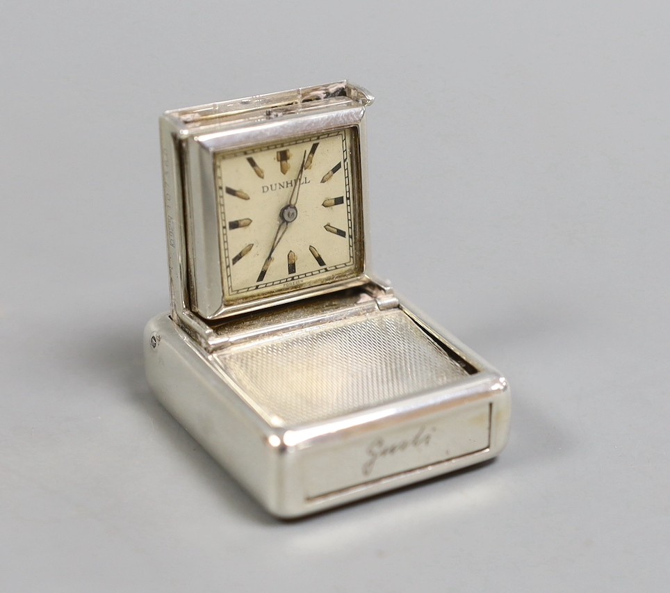 A 1930's engine turned silver traveling watch, retailed by Dunhill, with engraved name, import marks for Hernu, Peron & Stockwell Ltd? London, 1937, 35mm.